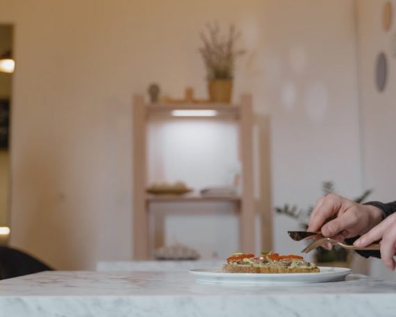 A man enjoying a healthy vegan meal in a cozy indoor cafe setting.